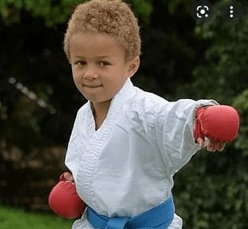 karate boy punching wiht wkf approved gloves